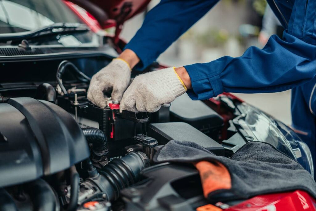 A professional Powers Transmissions team member working under the hood of a client's vehicle