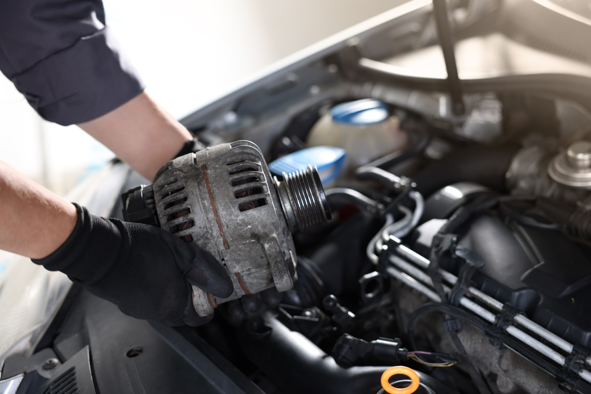 A Powers Transmissions technician working on an alternator replacement near Lexington, KY, for a client